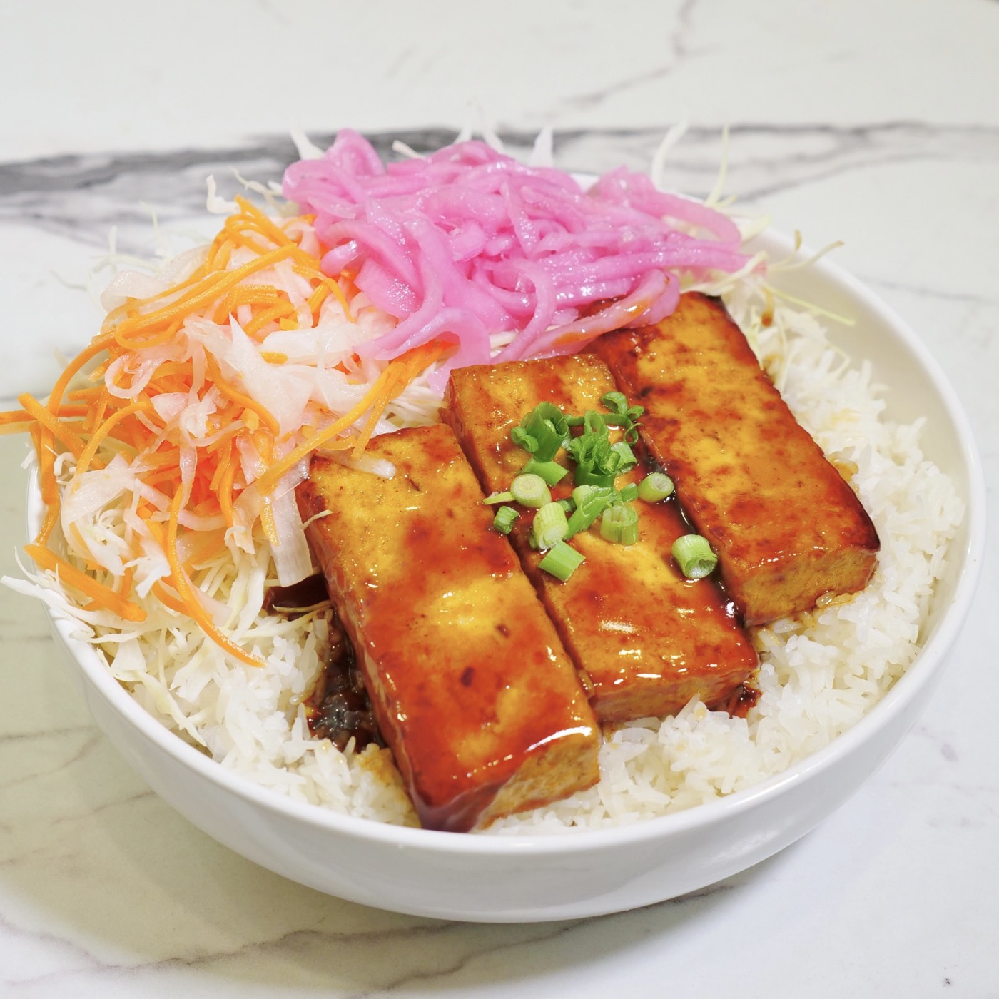 Sweet Chili Tofu rice bowl with pickled red onions